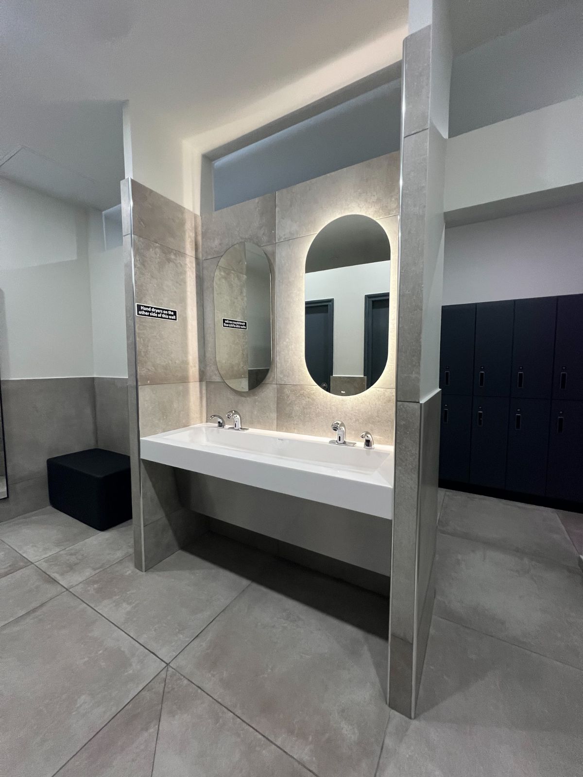 Sinks with backlit mirrors in the changing room