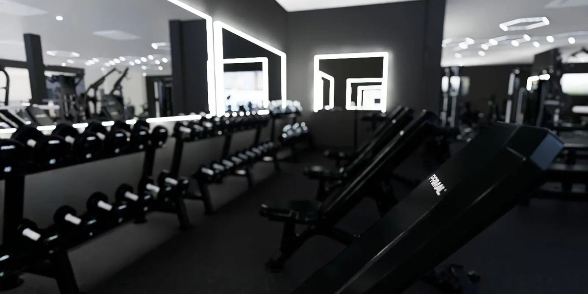 Dumbbell racks, Primal adjustable benches and lit mirrors at Solis Body Club