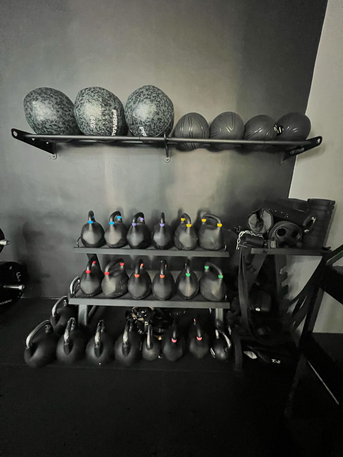 Kettlebells and medicine balls on wall racks