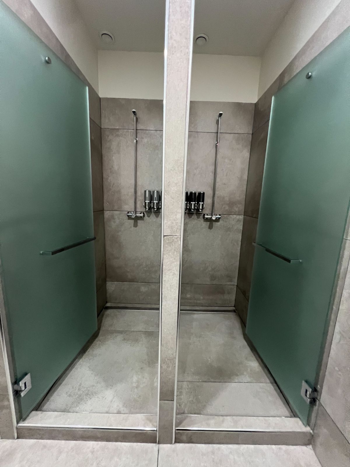 Private showers with frosted glass doors