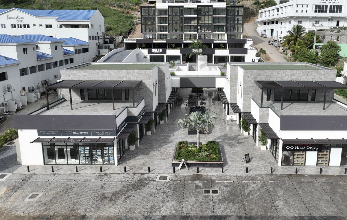 Aerial view of The Hills Residence, Simpson Bay: Solis Body Club signs at the top, the courtyard and the front parking area